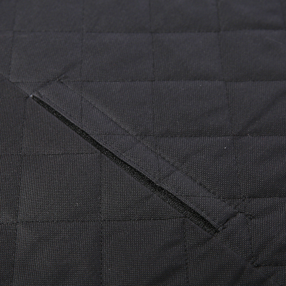 Close-up of a black quilted fabric with visible stitching