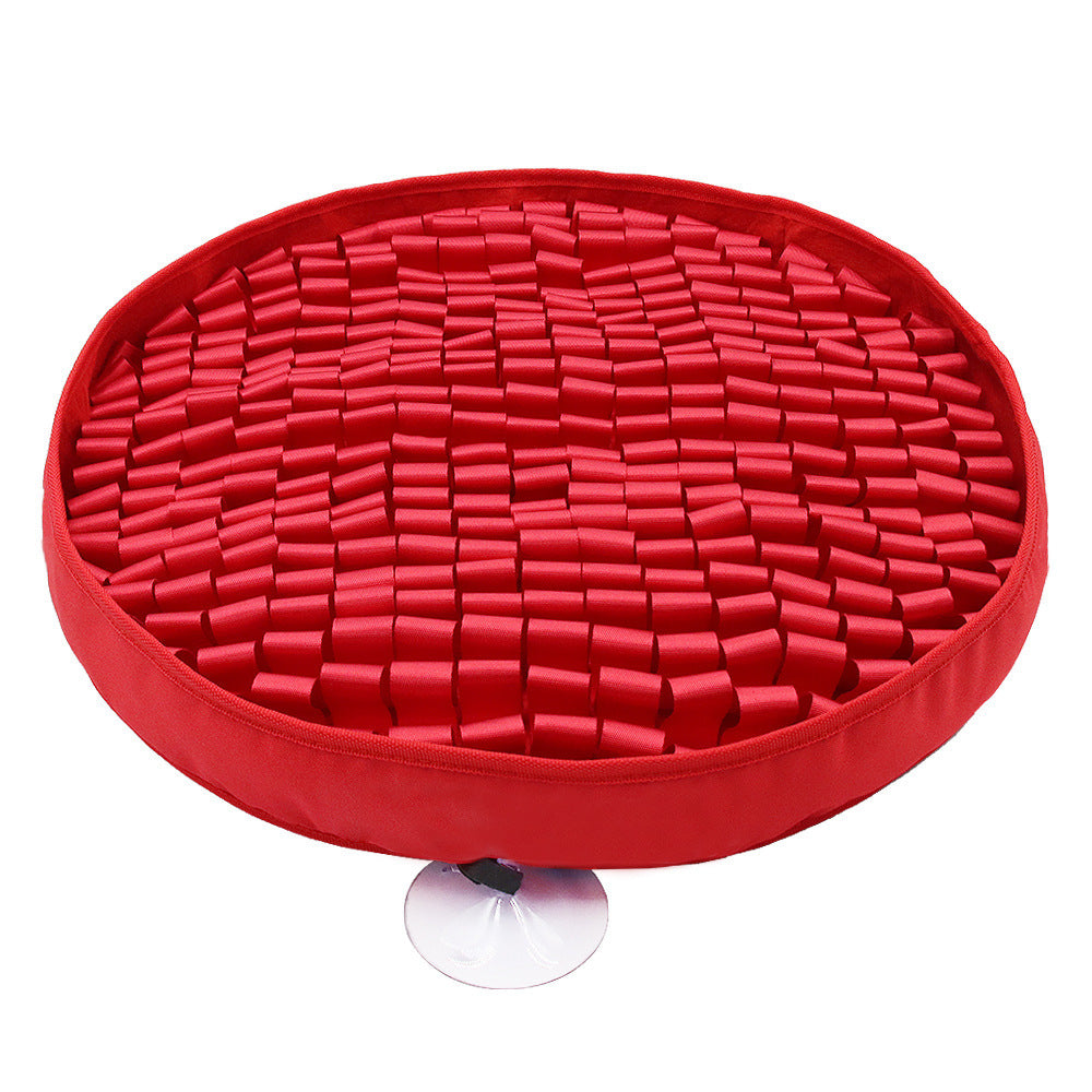 Red circular mat with textured surface on a white background