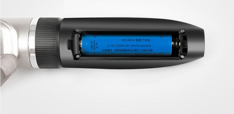 Close-up of a cylindrical electronic device with a blue label
