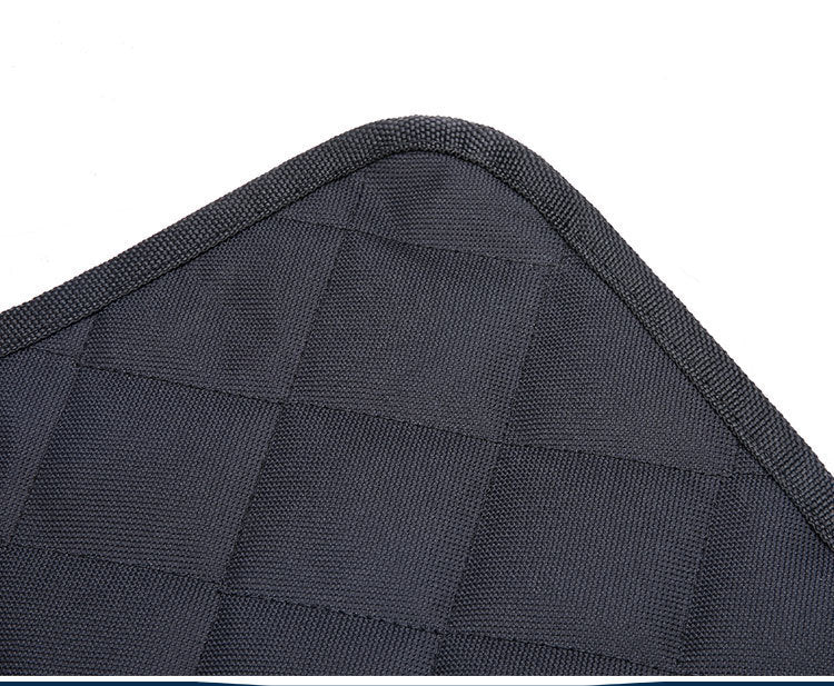 Close-up of a textured black car seat cover with a diamond pattern.
