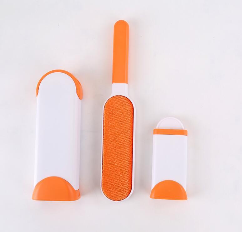 Three orange and white grooming tools