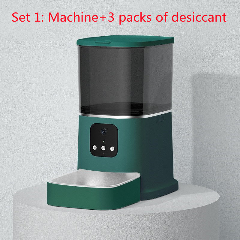 Green pet feeder on a white pedestal with text indicating 'Set 1: Machine + 3 packs of desiccant' on a light gray background.
