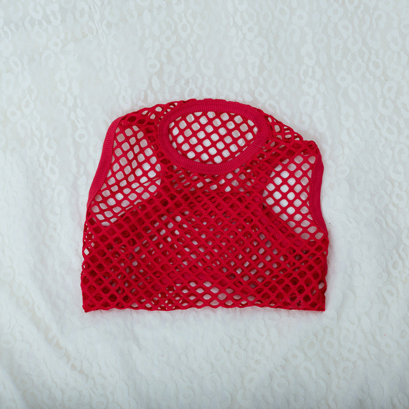 Red mesh bag on a white textured background