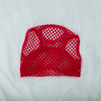 Red mesh bag on a white textured background