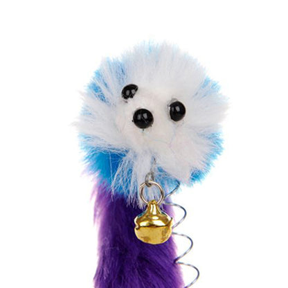 Plush toy with blue, white, and purple fur and a gold bell on a white background