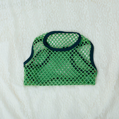 Green mesh pet carrier on a textured white background