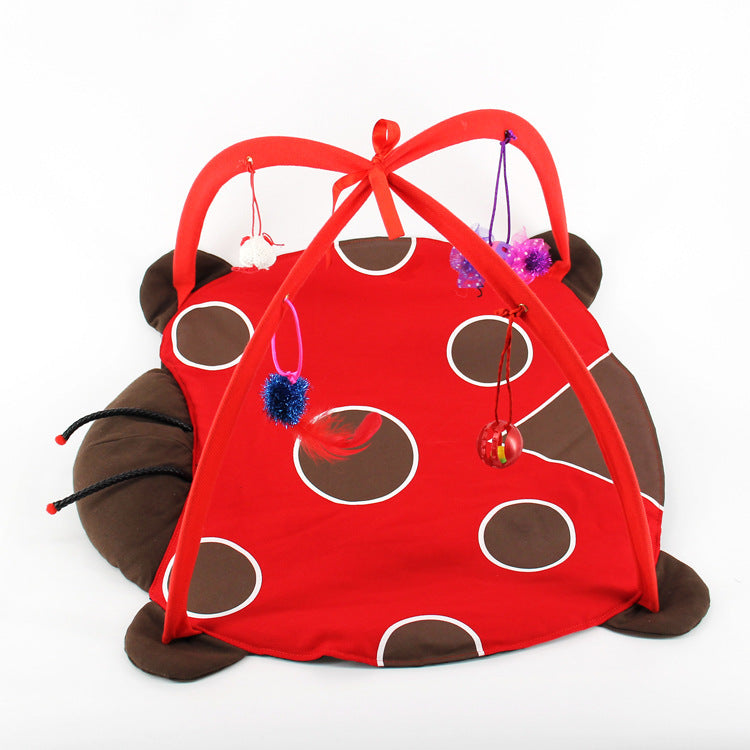 Red ladybug-shaped play tent with brown spots on a white background