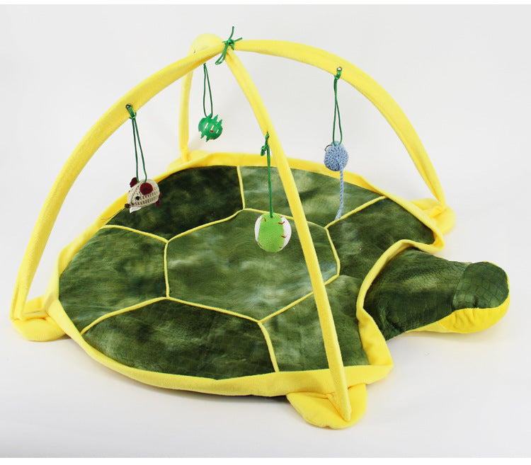 Tortoise-shaped play mat with hanging toys on a white background