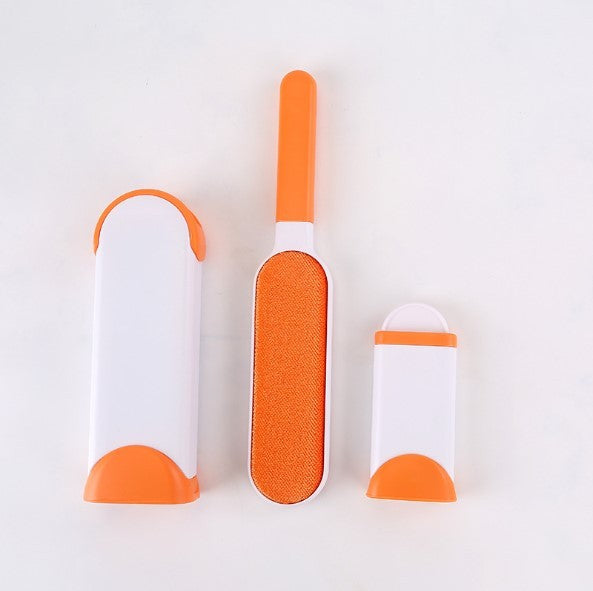 Three orange and white pet grooming tools