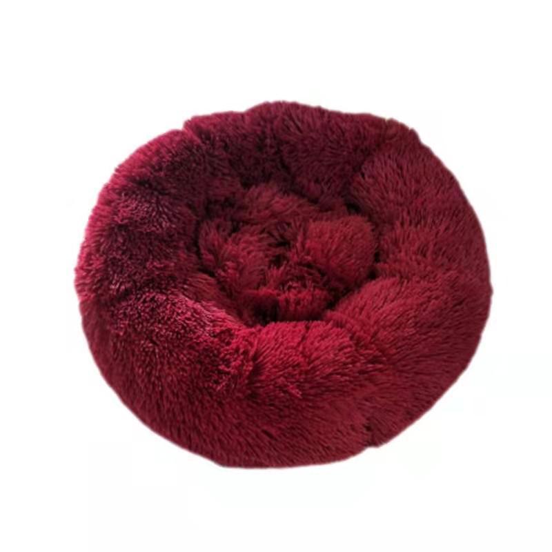 Red fluffy donut pet bed on a white background