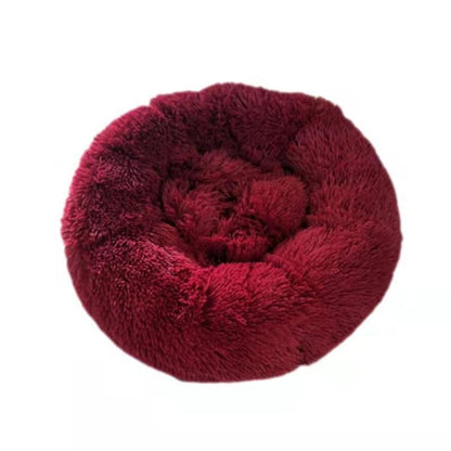Red fluffy donut pet bed on a white background