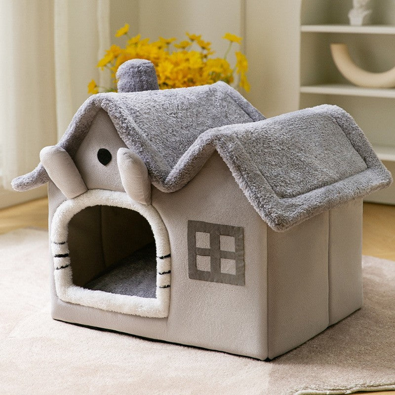 Cat house with a gray roof and beige body on a light-colored floor.