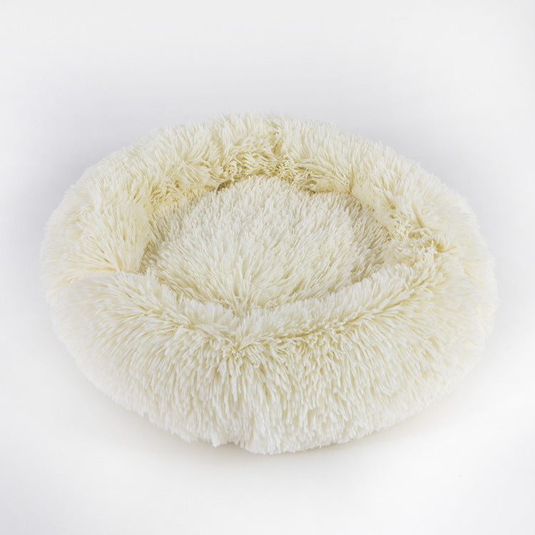 Round, plush pet bed on a white background