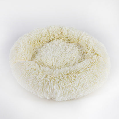 Round, plush pet bed on a white background