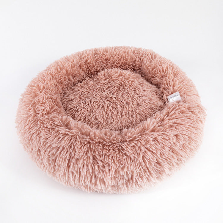 Fluffy pink pet bed on a white background