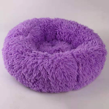 Purple fluffy pet bed on a white background