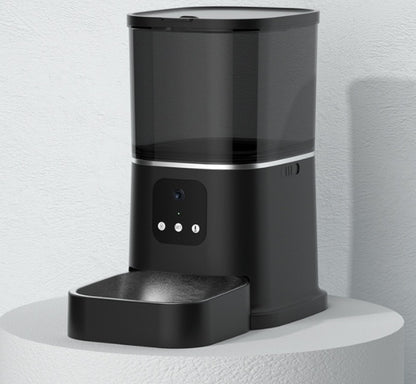 Black pet feeder on a white surface with a light gray background